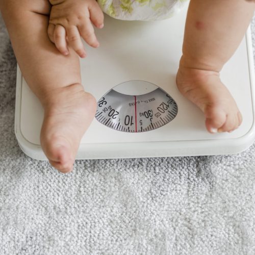 Closeup of a baby's legs on a weighing scale