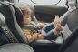 Toddler inside a car sit in her baby safety seat